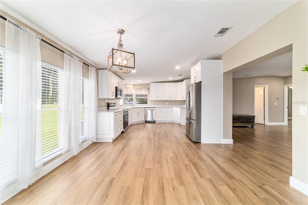6155 Southeast Stetson Road Belleview, FL 34420 - Photo 15 of 68 a view of a kitchen with wooden floor electronic appliances and windows