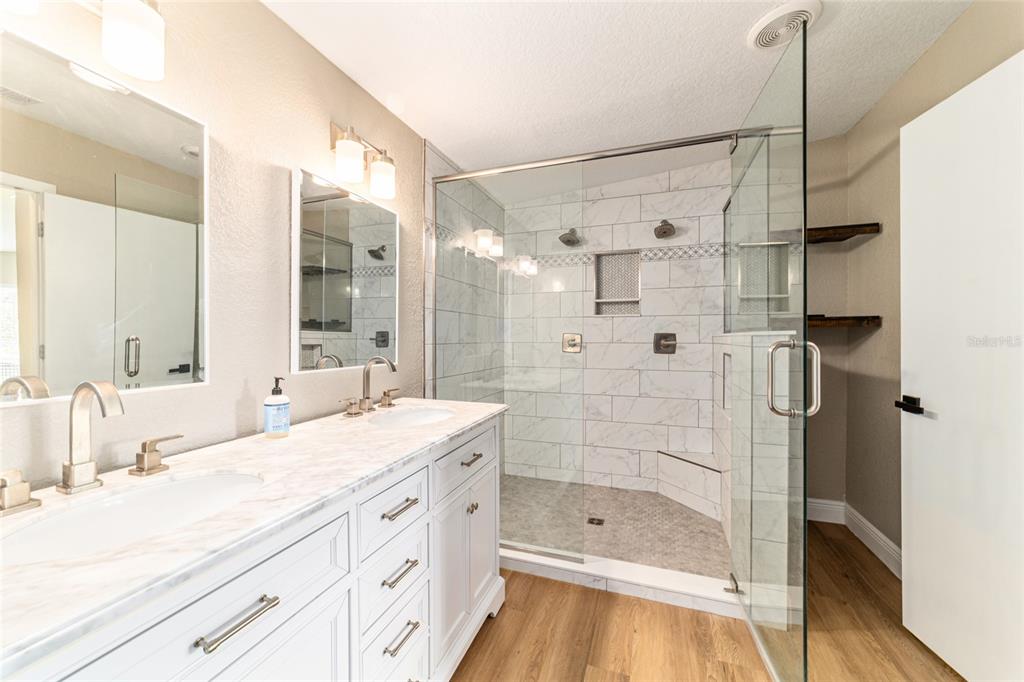 6155 Southeast Stetson Road Belleview, FL 34420 - Photo 26 of 68 a bathroom with a granite countertop sink mirror and shower