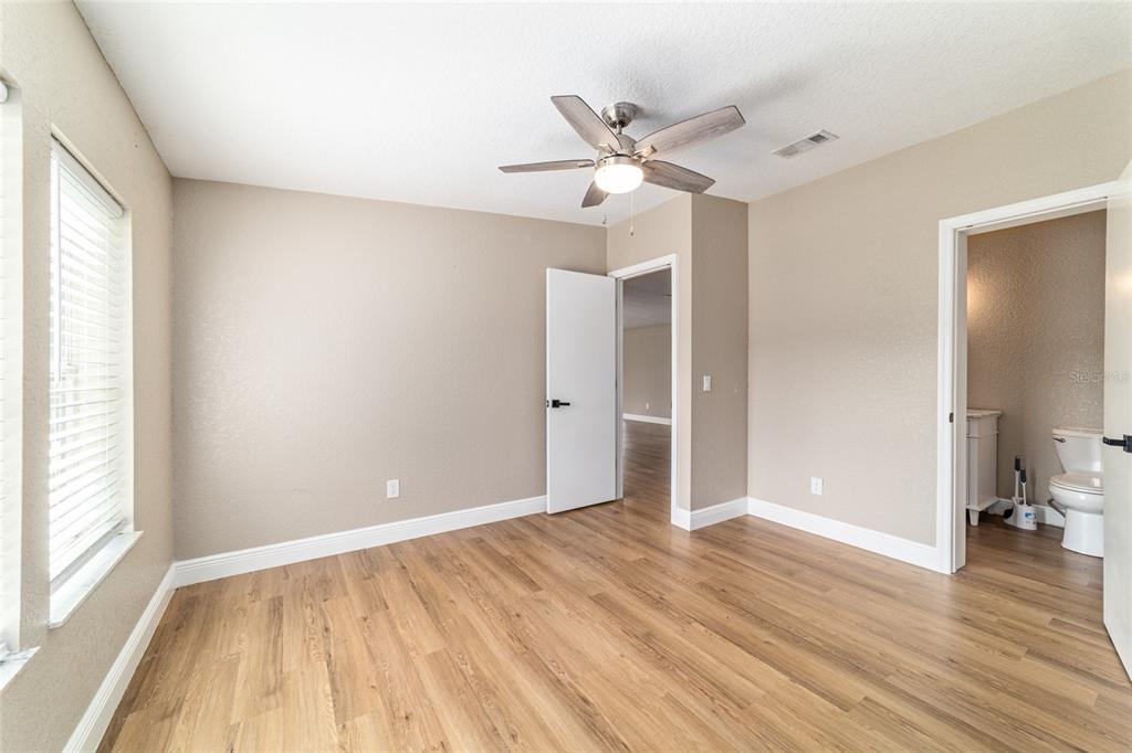 6155 Southeast Stetson Road Belleview, FL 34420 - Photo 28 of 68 wooden floor in an empty room with a window