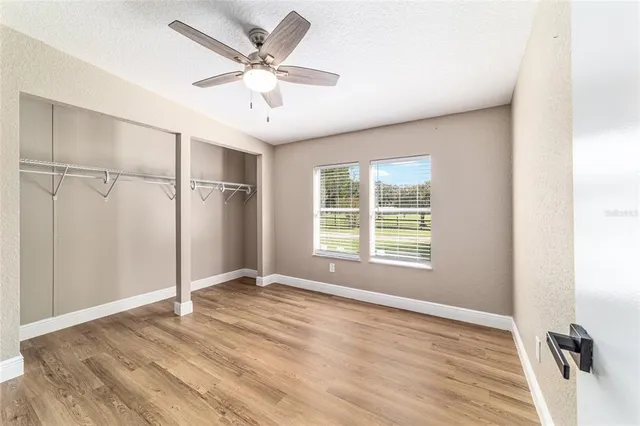 a kitchen with a refrigerator and white cabinets