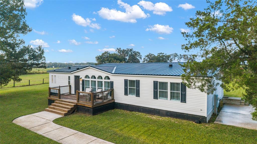 6155 Southeast Stetson Road Belleview, FL 34420 - Photo 3 of 68 a front view of a house with a garden