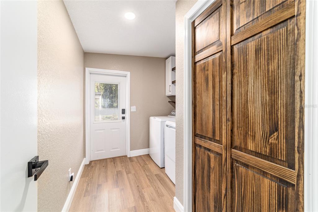 6155 Southeast Stetson Road Belleview, FL 34420 - Photo 33 of 68 a view of a hallway with wooden floor and staircase