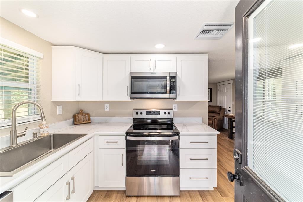 6155 Southeast Stetson Road Belleview, FL 34420 - Photo 40 of 68 a kitchen with a stove and a sink