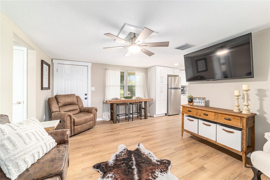 6155 Southeast Stetson Road Belleview, FL 34420 - Photo 47 of 68 a living room with furniture and a flat screen tv