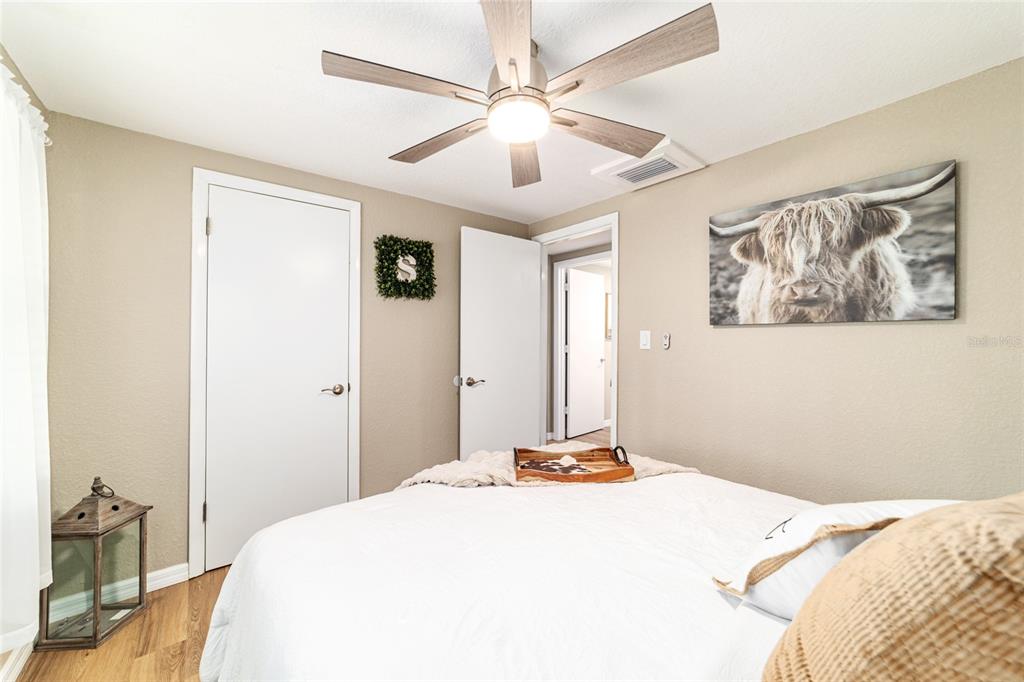 6155 Southeast Stetson Road Belleview, FL 34420 - Photo 49 of 68 a bedroom with a bed and a chandelier