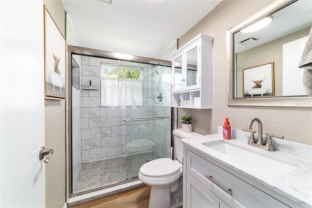 6155 Southeast Stetson Road Belleview, FL 34420 - Photo 51 of 68 a bathroom with a sink toilet and shower