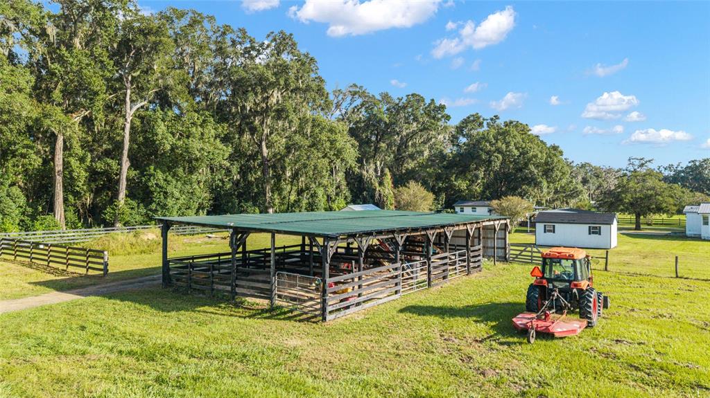 6155 Southeast Stetson Road Belleview, FL 34420 - Photo 57 of 68 a view of a swimming pool with a deck and a garden