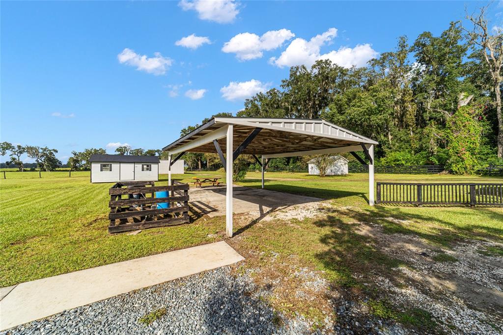 6155 Southeast Stetson Road Belleview, FL 34420 - Photo 58 of 68 a view of a house with yard and sitting area
