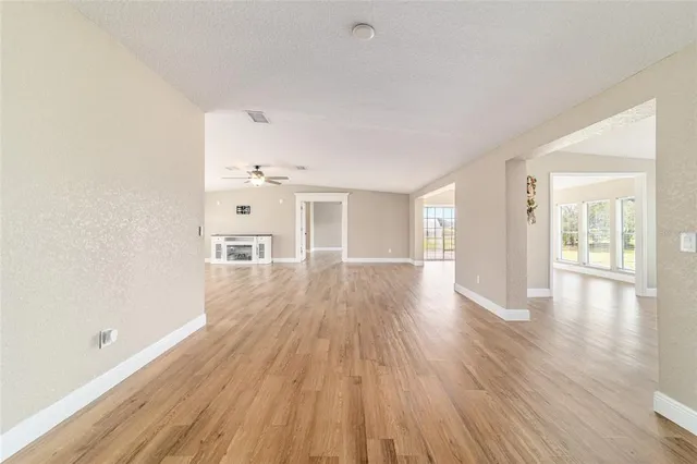 a kitchen with stainless steel appliances granite countertop a stove top oven a sink dishwasher and a refrigerator with wooden floor