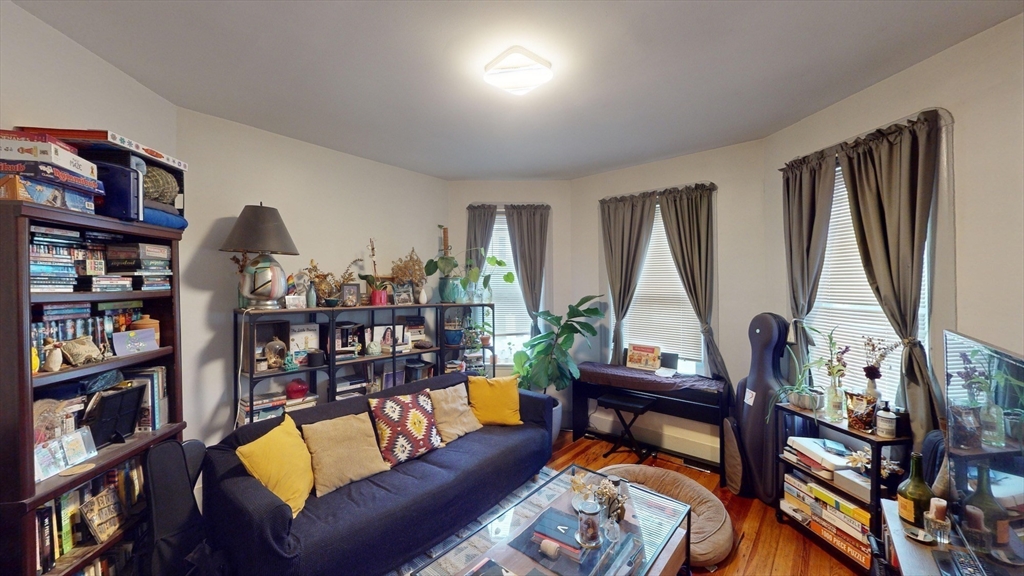 22 Boynton Street Boston, MA 02130 - Photo 11 of 34 a living room with furniture a bookshelf and a window