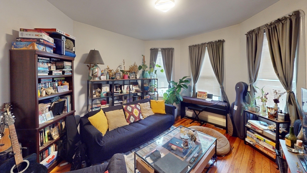 22 Boynton Street Boston, MA 02130 - Photo 13 of 34 a living room with furniture a bookshelf and a window