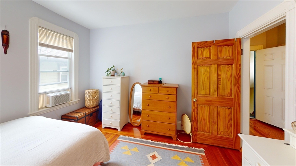 22 Boynton Street Boston, MA 02130 - Photo 18 of 34 a bedroom with a bed and wooden floor