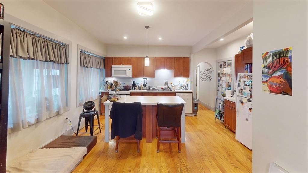 22 Boynton Street Boston, MA 02130 - Photo 22 of 34 a dining hall with stainless steel appliances granite countertop a refrigerator and a wooden cabinets