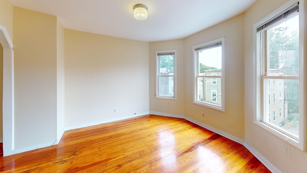 22 Boynton Street Boston, MA 02130 - Photo 23 of 34 a view of a bedroom with wooden floor and windows
