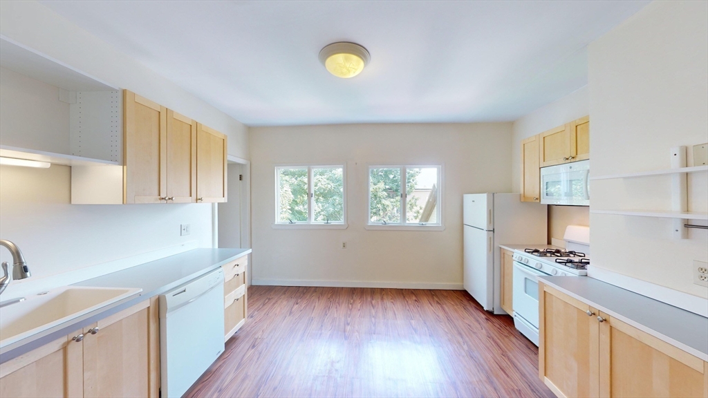 22 Boynton Street Boston, MA 02130 - Photo 28 of 34 a kitchen with cabinets and wooden floor