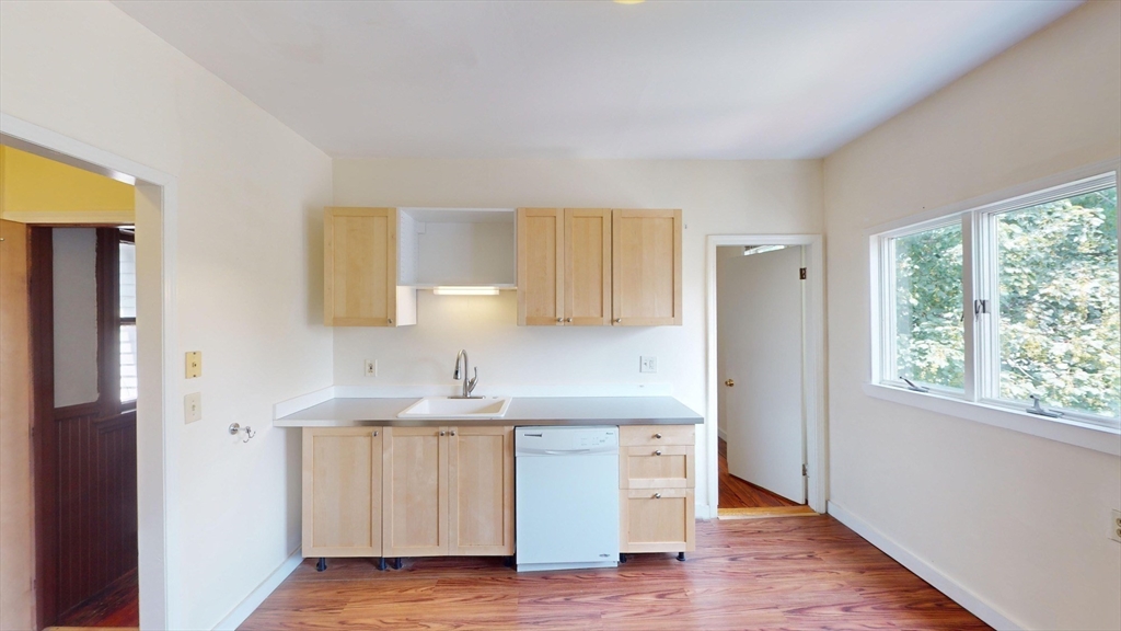 22 Boynton Street Boston, MA 02130 - Photo 29 of 34 a kitchen with a sink cabinets and a window