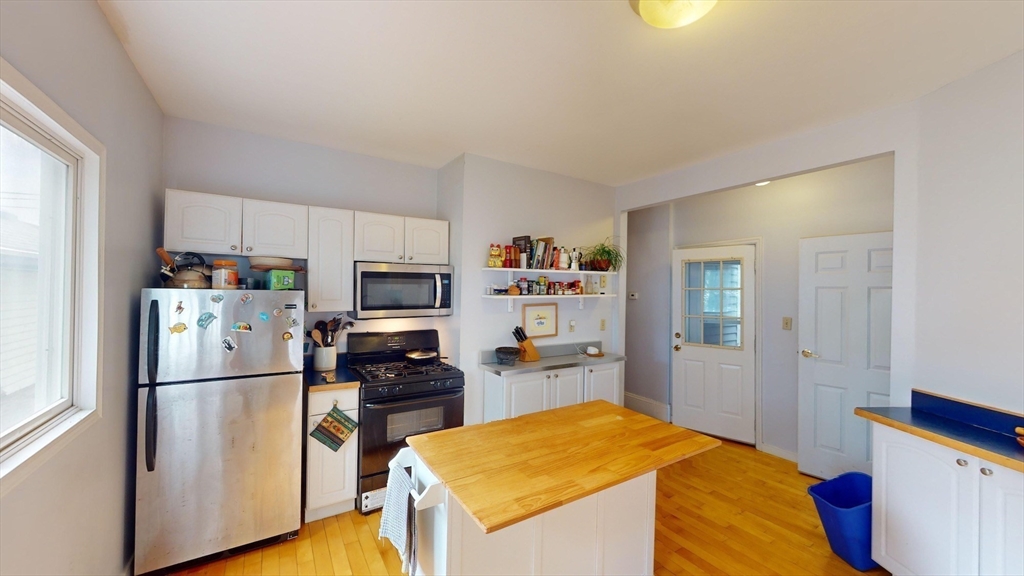 22 Boynton Street Boston, MA 02130 - Photo 8 of 34 a kitchen with a refrigerator and a stove top oven