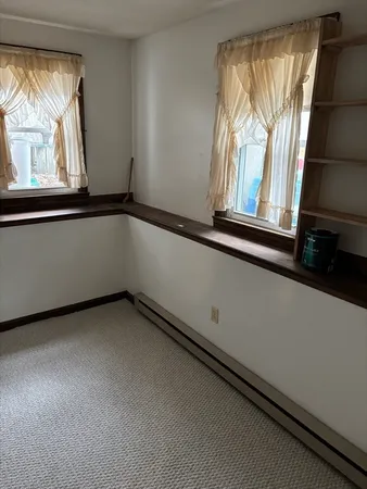 a kitchen with a refrigerator and window