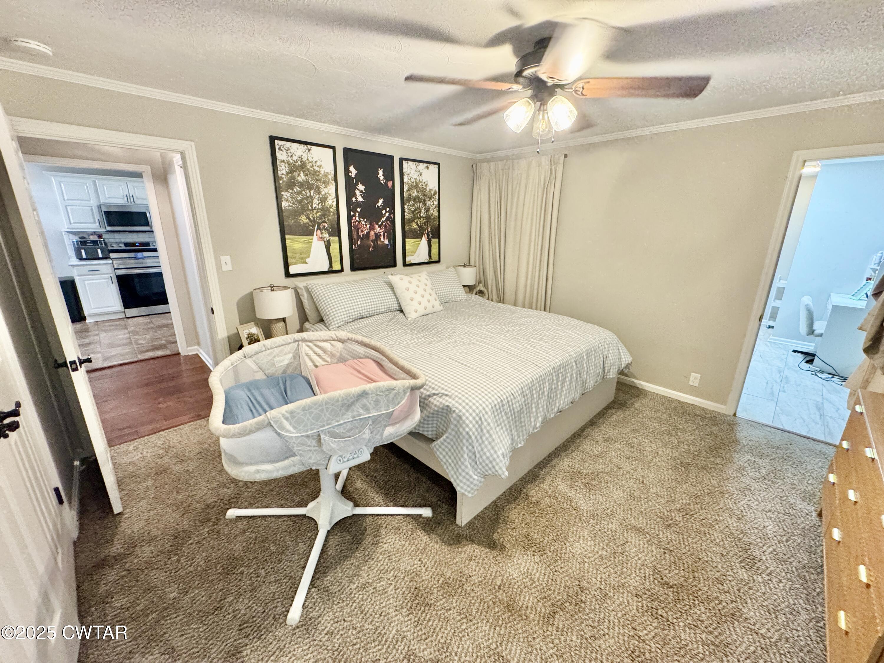 302 Flora Circle Newbern, TN 38059 - Photo 11 of 20 a bedroom with a bed and a chandelier