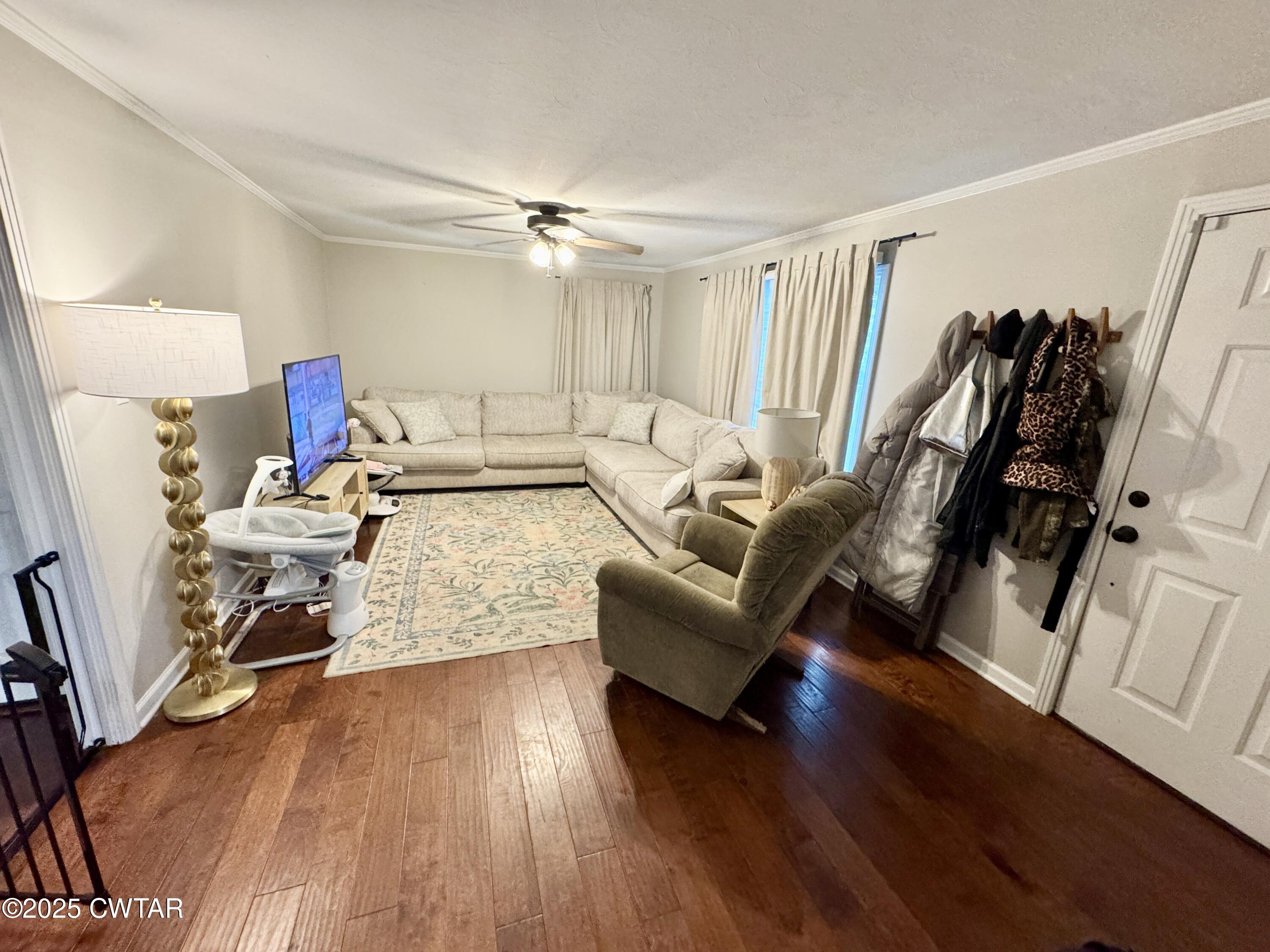 302 Flora Circle Newbern, TN 38059 - Photo 15 of 20 a living room with furniture and a wooden floor