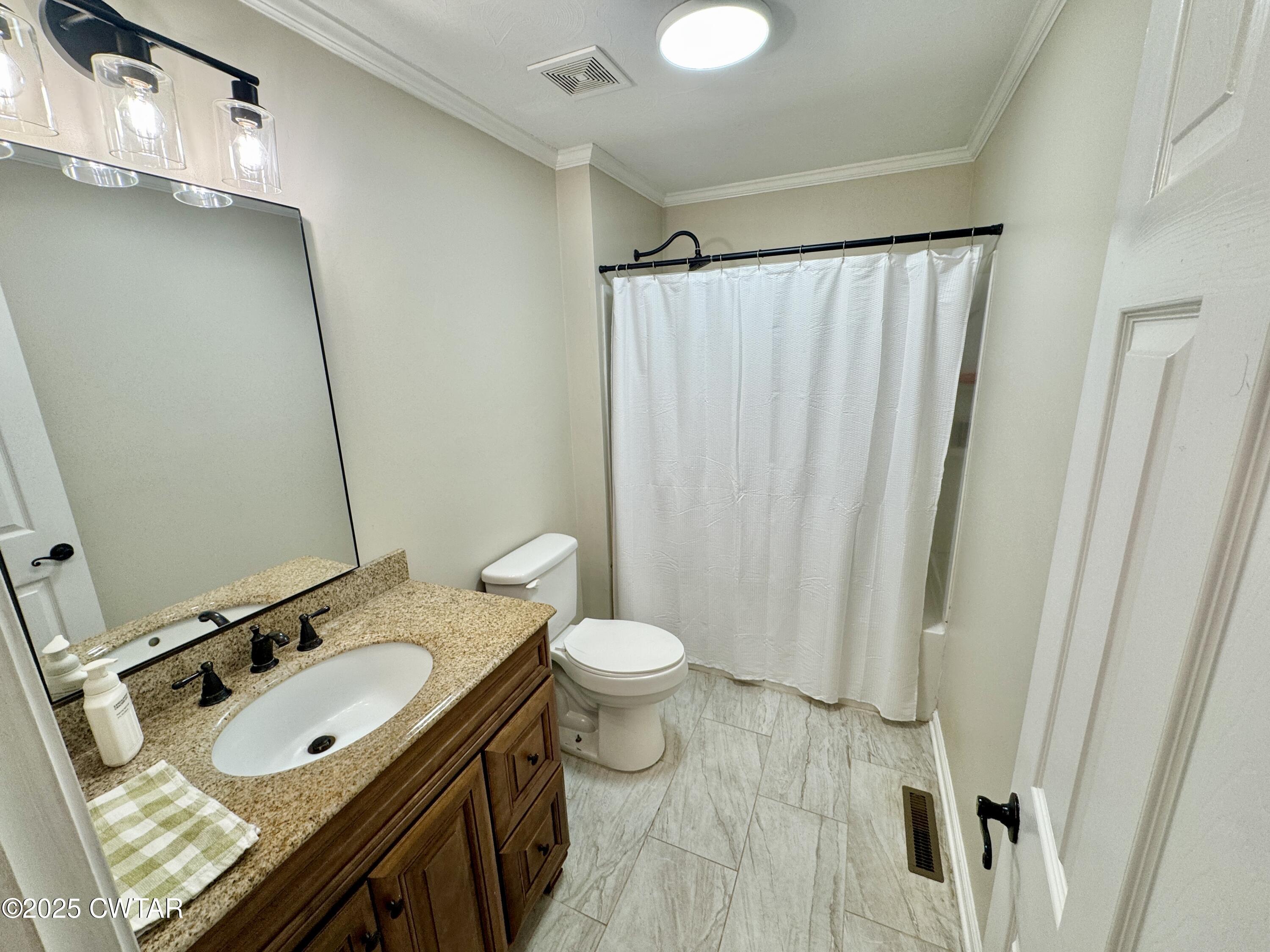 302 Flora Circle Newbern, TN 38059 - Photo 18 of 20 a bathroom with a granite countertop sink toilet and shower