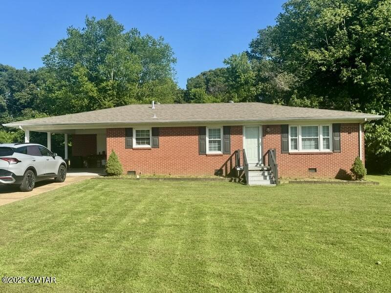 302 Flora Circle Newbern, TN 38059 - Photo 19 of 20 a view of a house with backyard
