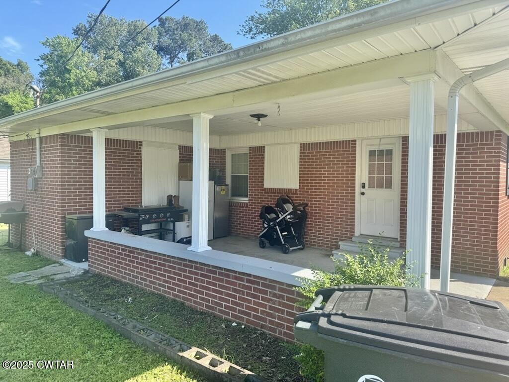 302 Flora Circle Newbern, TN 38059 - Photo 3 of 20 a view of a house with porch and chairs