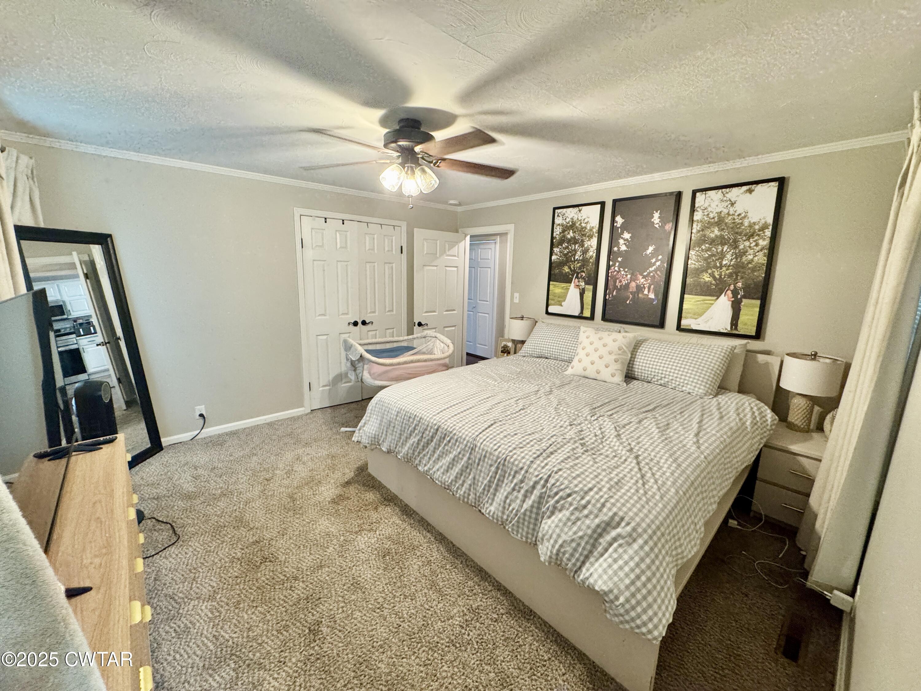 302 Flora Circle Newbern, TN 38059 - Photo 10 of 20 a bedroom with a large bed and a flat tv screen on dresser