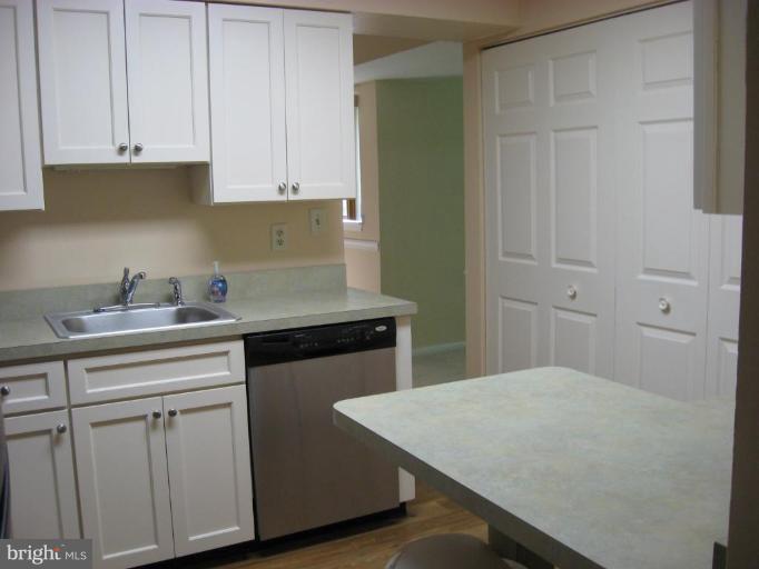 2901 Fallstaff Road, Unit 205 Baltimore, MD 21209 - Photo 3 of 13 a kitchen with white cabinets and sink