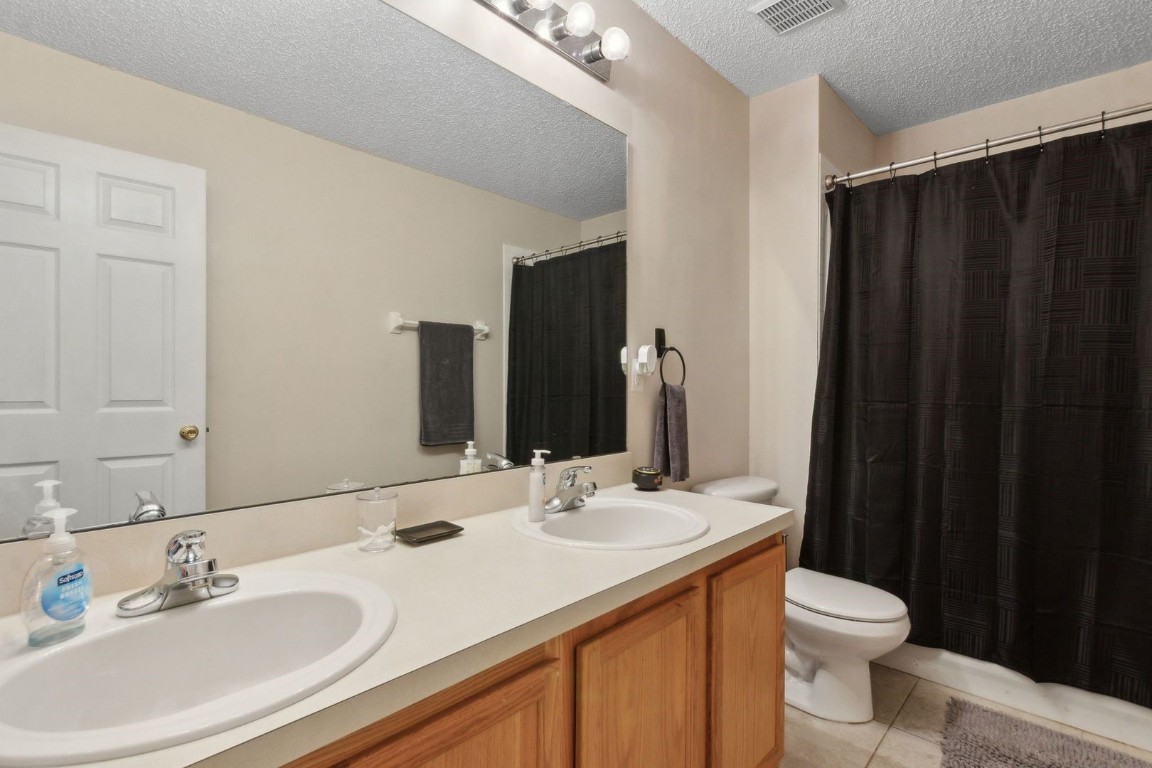96696 Commodore Point Drive Yulee, FL 32097 - Photo 12 of 21 a bathroom with a double vanity sink toilet and a mirror