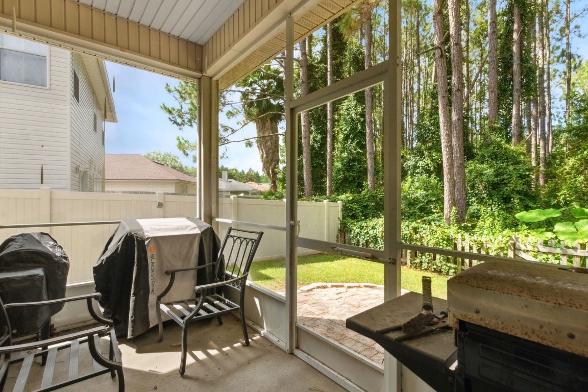 96696 Commodore Point Drive Yulee, FL 32097 - Photo 16 of 21 a view of a patio with table and chairs and wooden floor