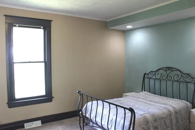 a bathroom with a sink a mirror and wooden floor