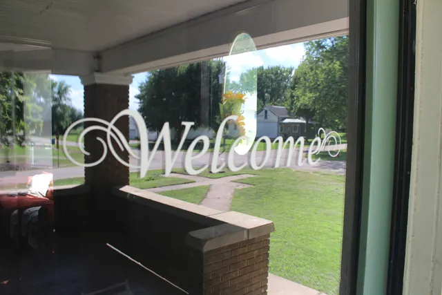 a view of a patio with dining table and chairs