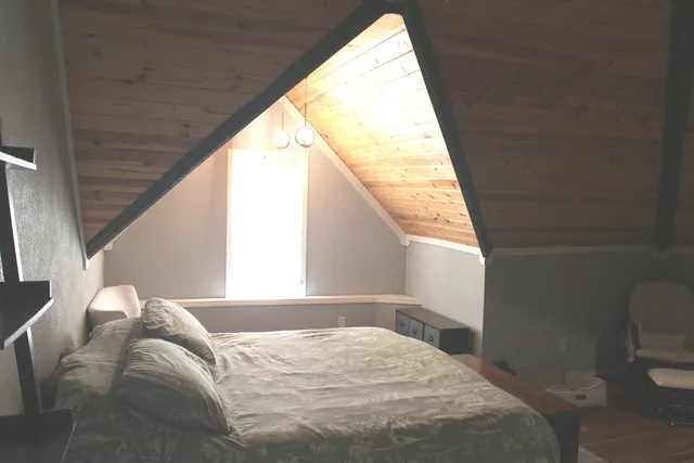 a bathroom with a sink mirror toilet and window