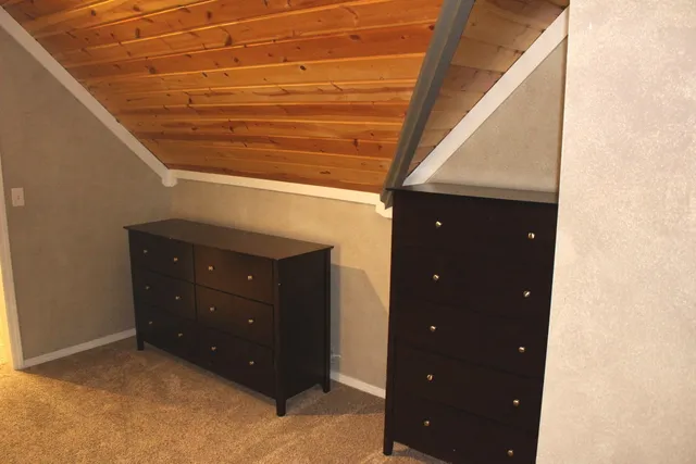 a view of a wooden house with a bench