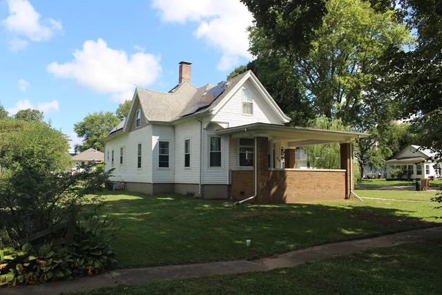 a front view of house with yard and green space