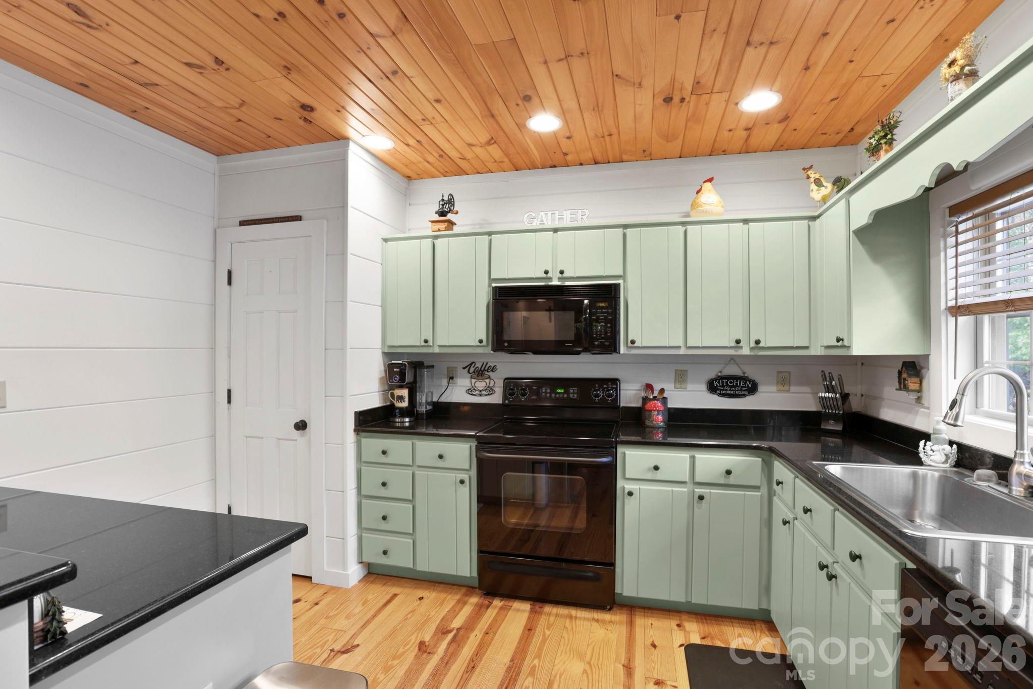 78 Longview Ridge Lake Toxaway, NC 28747 - Photo 14 of 43 a kitchen with stainless steel appliances granite countertop a sink stove and refrigerator