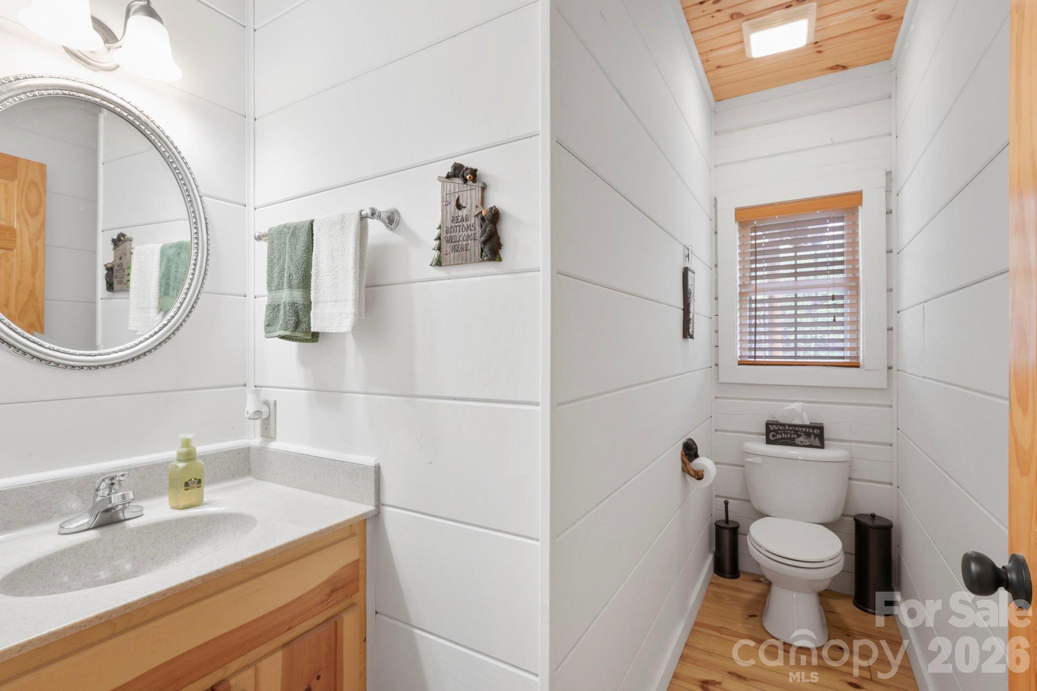 78 Longview Ridge Lake Toxaway, NC 28747 - Photo 17 of 43 a bathroom with a sink toilet and a mirror