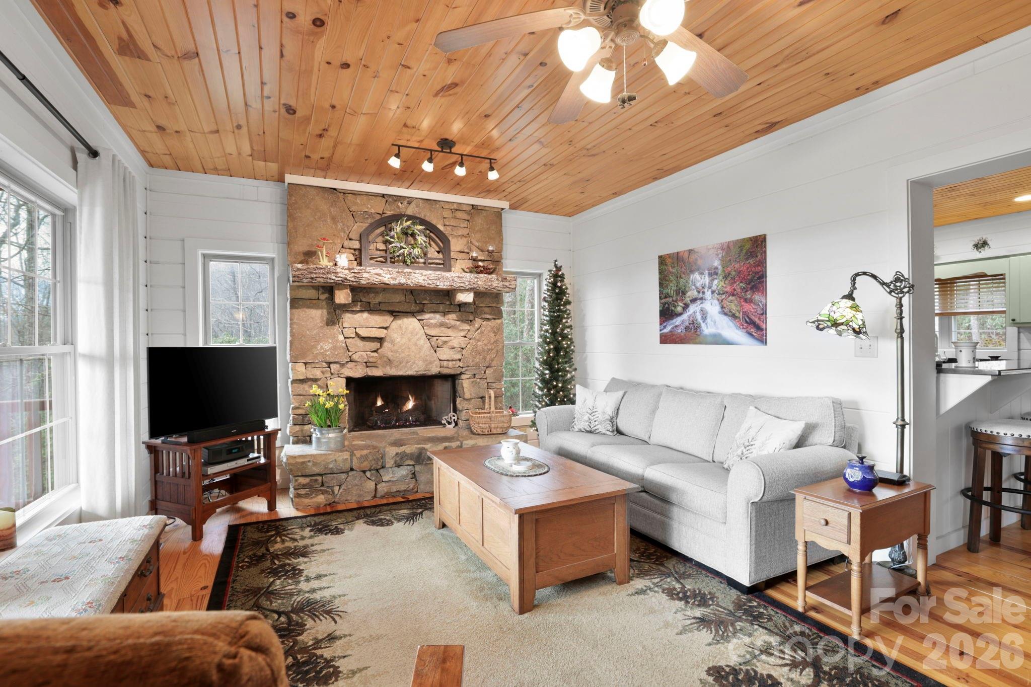 78 Longview Ridge Lake Toxaway, NC 28747 - Photo 2 of 43 a living room with furniture a fireplace and a flat screen tv