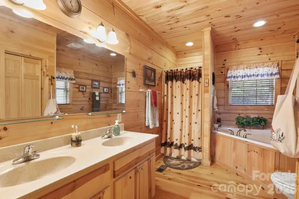 a bathroom with double vanity and a mirror