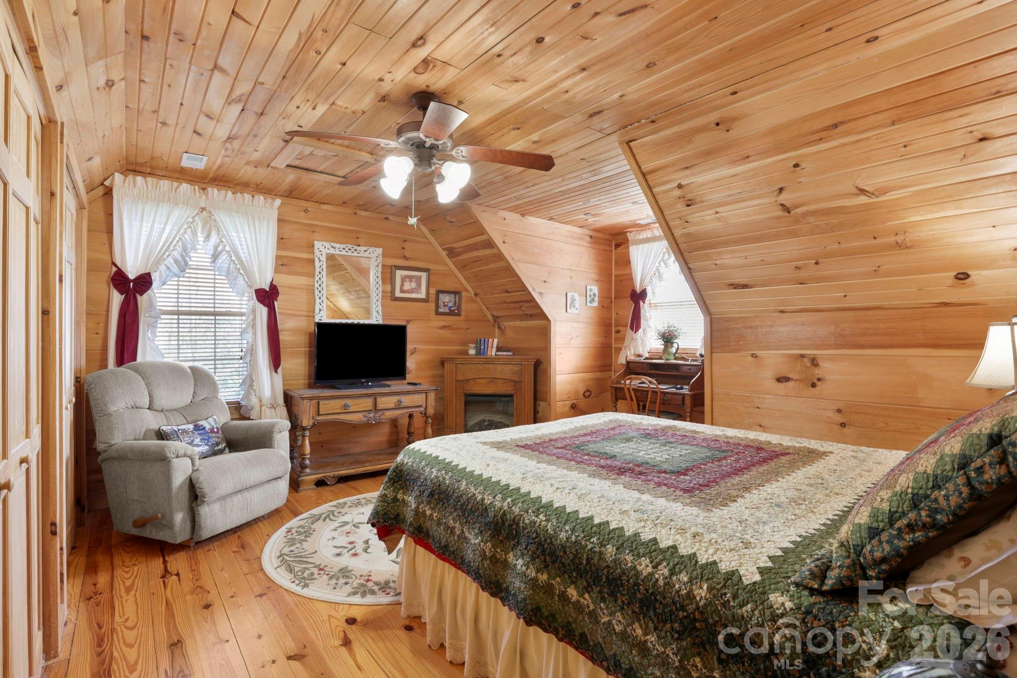 78 Longview Ridge Lake Toxaway, NC 28747 - Photo 25 of 43 a bedroom with a bed a couch and dresser