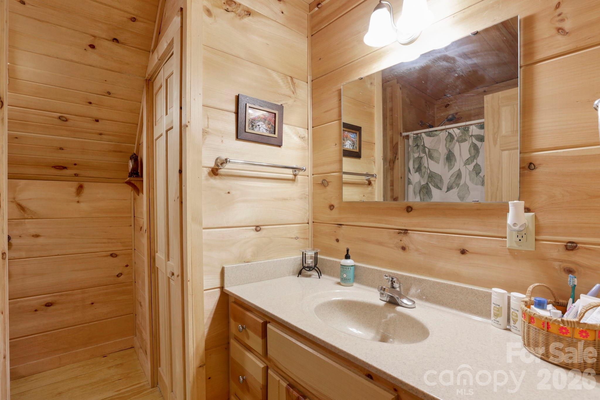 78 Longview Ridge Lake Toxaway, NC 28747 - Photo 28 of 43 a bathroom with a sink and a mirror