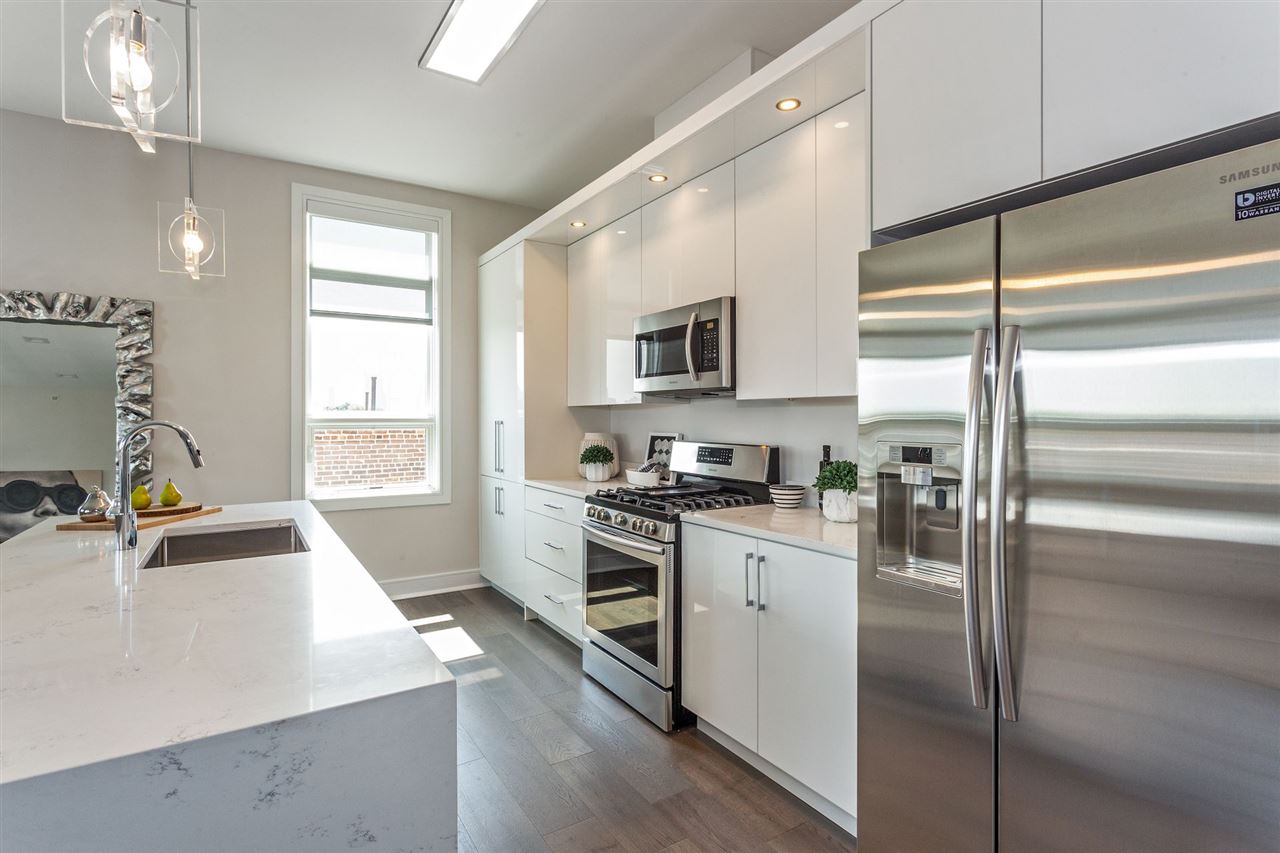 a kitchen with a stove a sink and a refrigerator