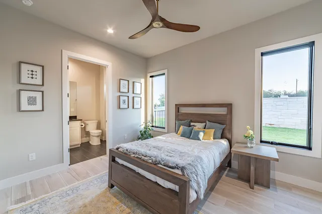 a bedroom with a large bed and a window