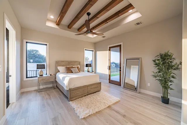 a bed room with a bed and a large window