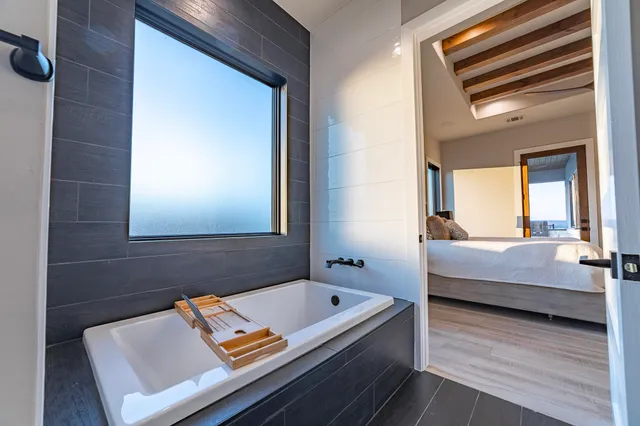 a bedroom with a bed and a window