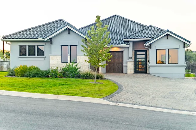 a front view of a house with a yard and garage