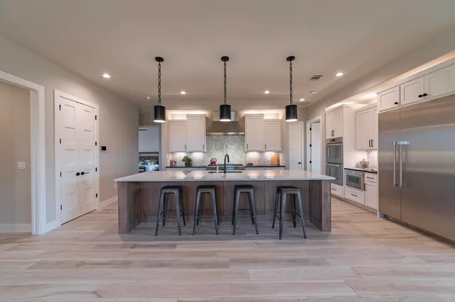 a large kitchen with a table and chairs