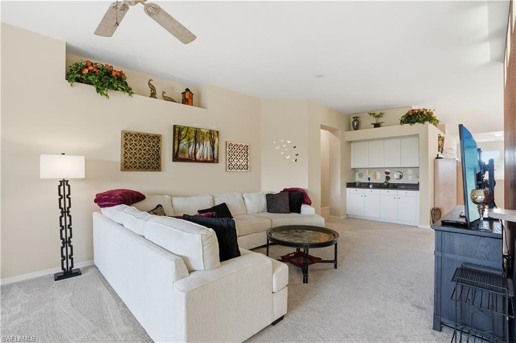 10871 Crooked River Road, Unit 202 Estero, FL 34135 - Photo 5 of 46 a living room with furniture and a flat screen tv