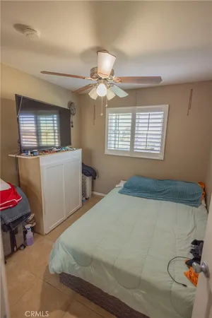 a bedroom with bed and window